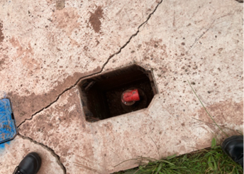 A valve chamber with considerable cracking on the concrete around it